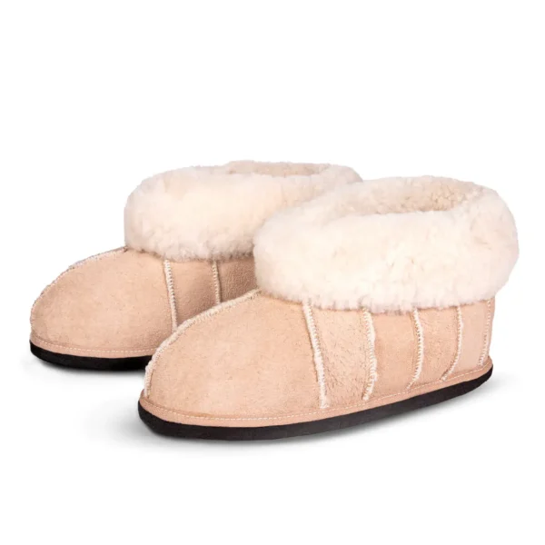 Pair of Lowveld Classic sheepskin slippers by JCP Leathers, displayed at a slight angle to show both side and front details.