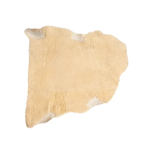 Natural medical sheepskin pad with dense wool fibres, shaped for pressure relief and comfort.