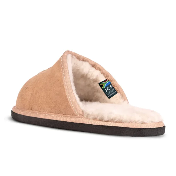 Side view of Kalahari Classic sheepskin slipper, highlighting the soft suede exterior, cosy fleece lining, and JCP South Africa label inside.