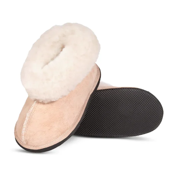 Karoo Classic sheepskin slipper shown at an angle, highlighting the soft suede upper, plush fleece collar, and textured black sole.