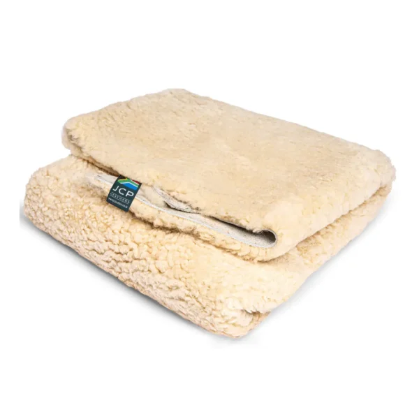 Folded medical-grade sheepskin showing plush wool texture and product tag.