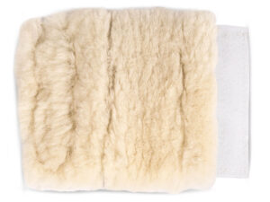 Straight-on view of a sheepskin medical grip with soft wool padding and a white velcro strap.