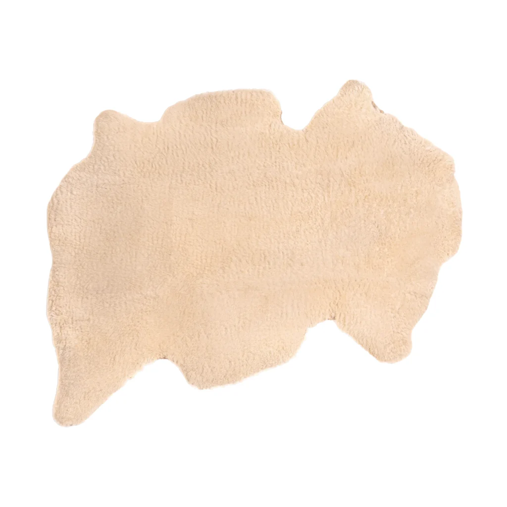 Top view of a soft, natural sheepskin baby rug.